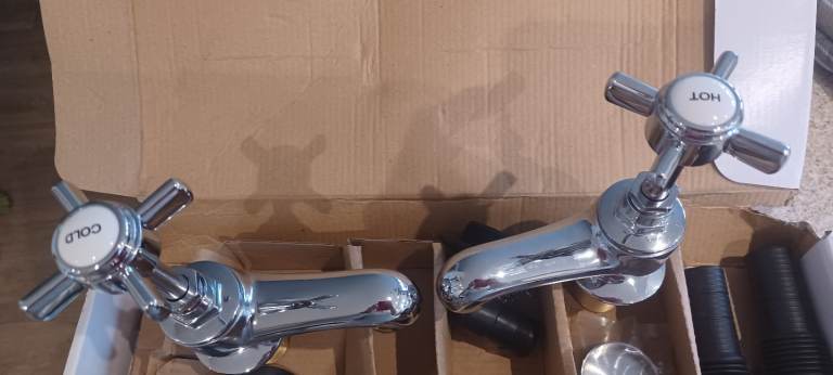 Unused kitchen taps with fittings still in box