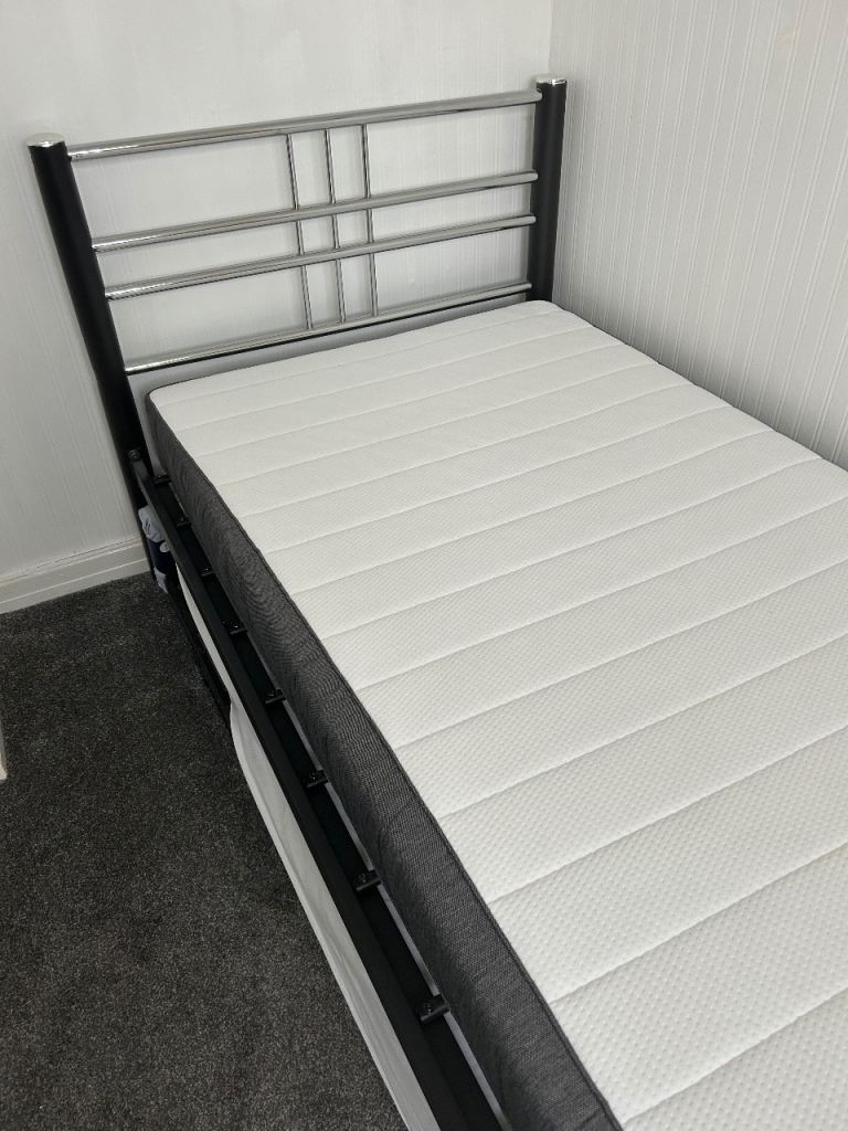 Single bed with a pull-out trundle bed underneath, perfect for guests.