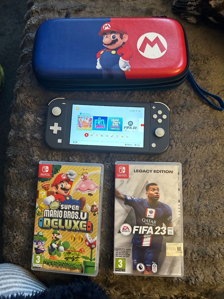 Nintendo Switch Lite in grey with case and 2 games