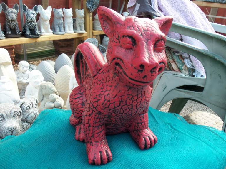 Concrete stone garden ornament statue of a friendly dragon