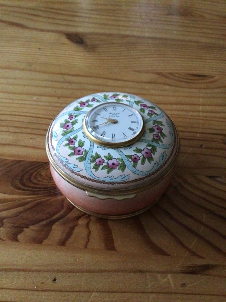 Halcyon Days salmon pink enamel trinket box with inset clock to lid.