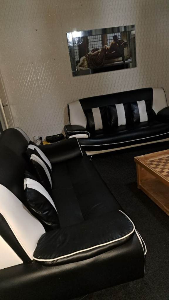 Two black and white leather sofas 