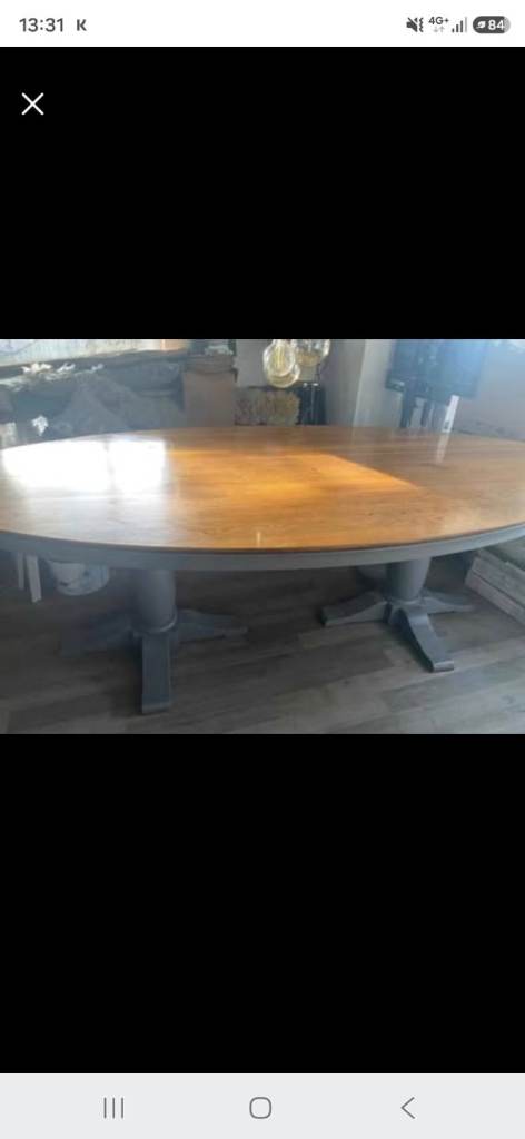 Oval oak twin legged dining table with chairs