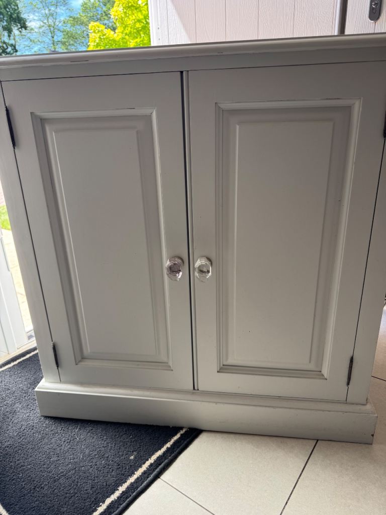 Painted storage cupboard with one shelf. 