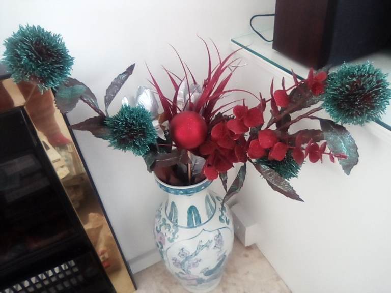 Attractive tall bunch of John Lewis Christmas artificial flowers.
