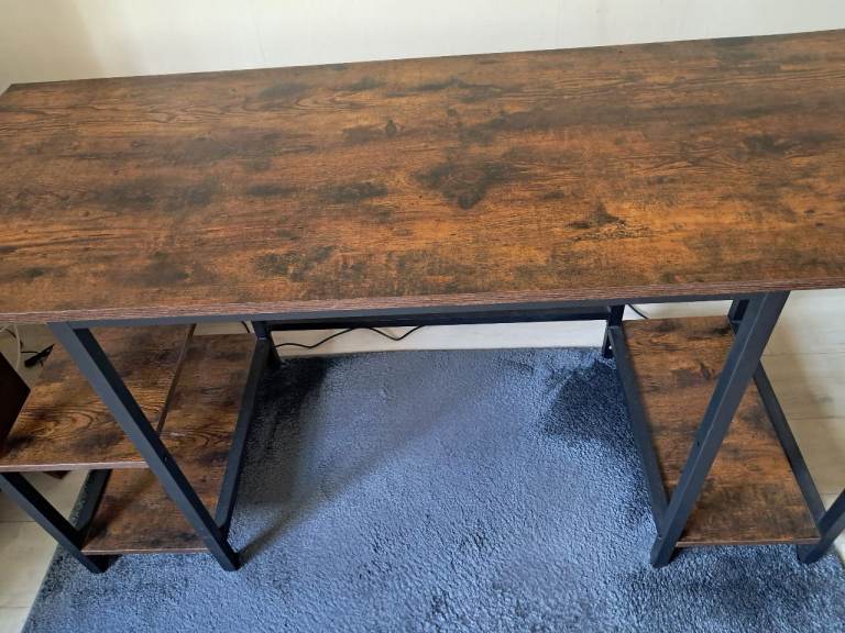 A sturdy desk with a nice wooden effect top and black metal frame
