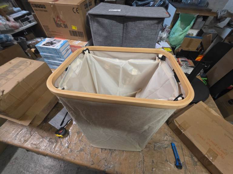 A new beige  canvas  laundry hamper .