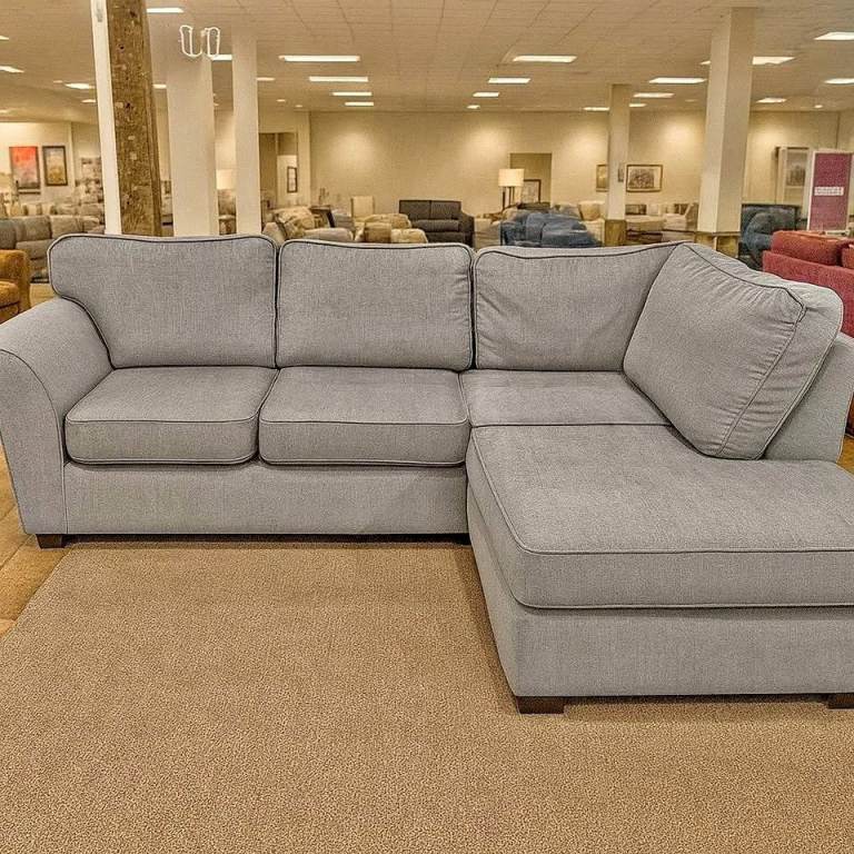 Comfortable grey corner sofa with a chaise lounge section, perfect for relaxing