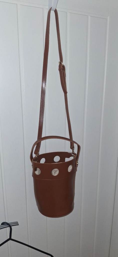 Brown bucket bag with hole detailing