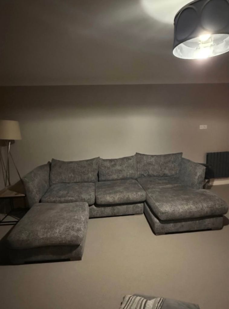 Large L shaped sofa with matching foot stall 