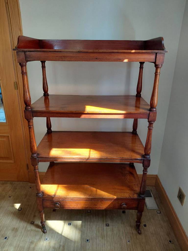 Antique Victorian 4-tier mahogany whatnot with a single drawer and castors.