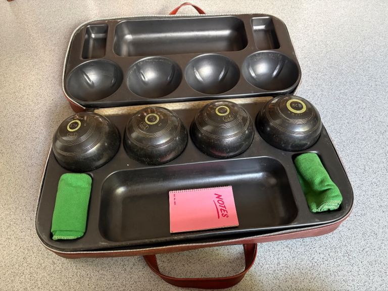 Four bowling balls and case