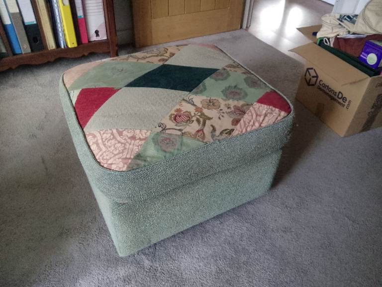 Upholstered stool on castors with reversible cushion