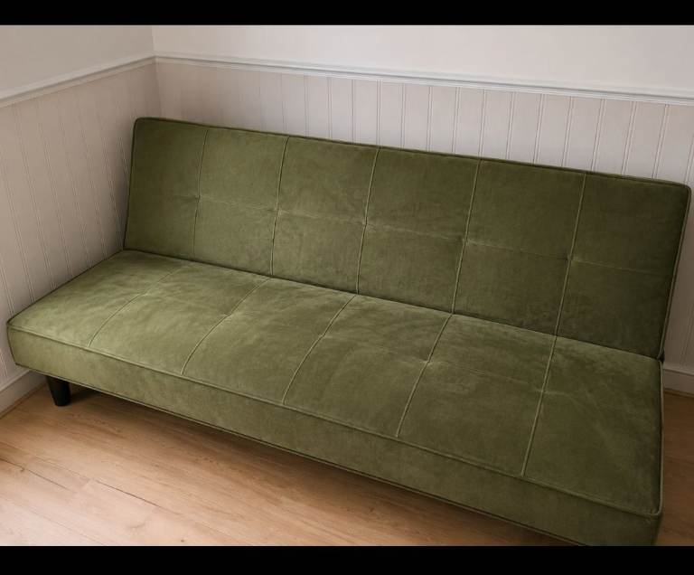 This is a green argos 2 seater sofa bed 