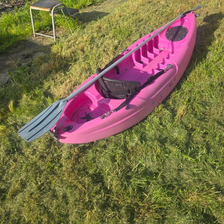 Kids sit on canoe