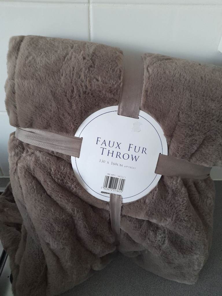 Throw blanket faux fur lovely quality. Cost £25, chocolate brown colour.