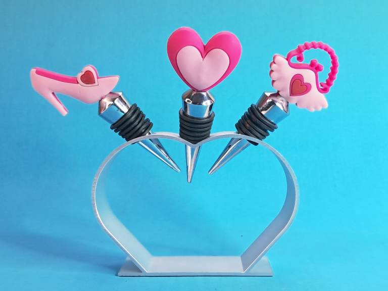 set of wine stoppers pink hearts and high-heeled shoe designs.