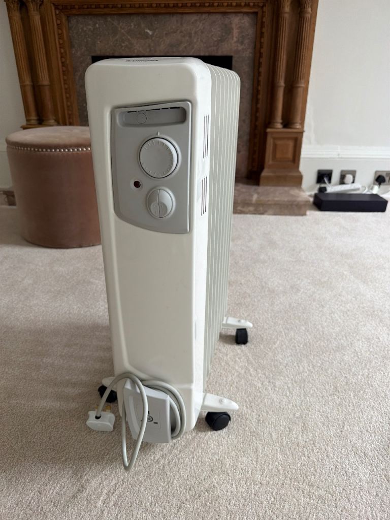 Waiting for collection—Free White Oil-Filled Radiator on Wheels – Good Condition