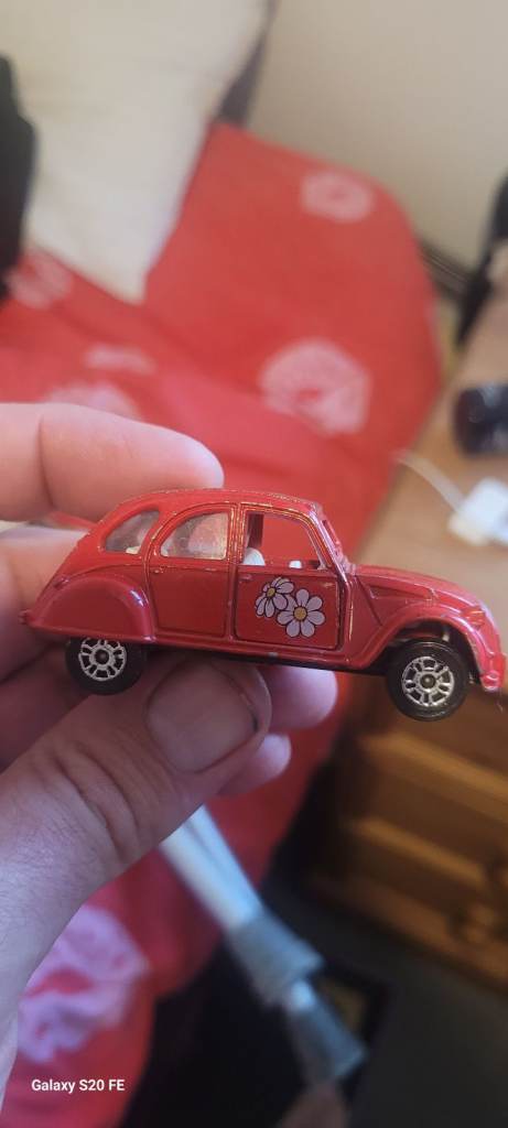 Red Toy Car with Flower Decal – Good Condition