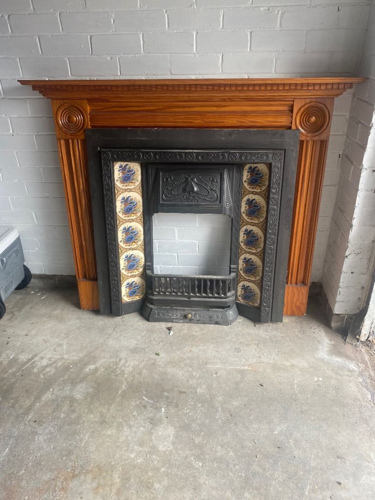 Traditional Wooden mantle and Fireplace with Decorative Tiles