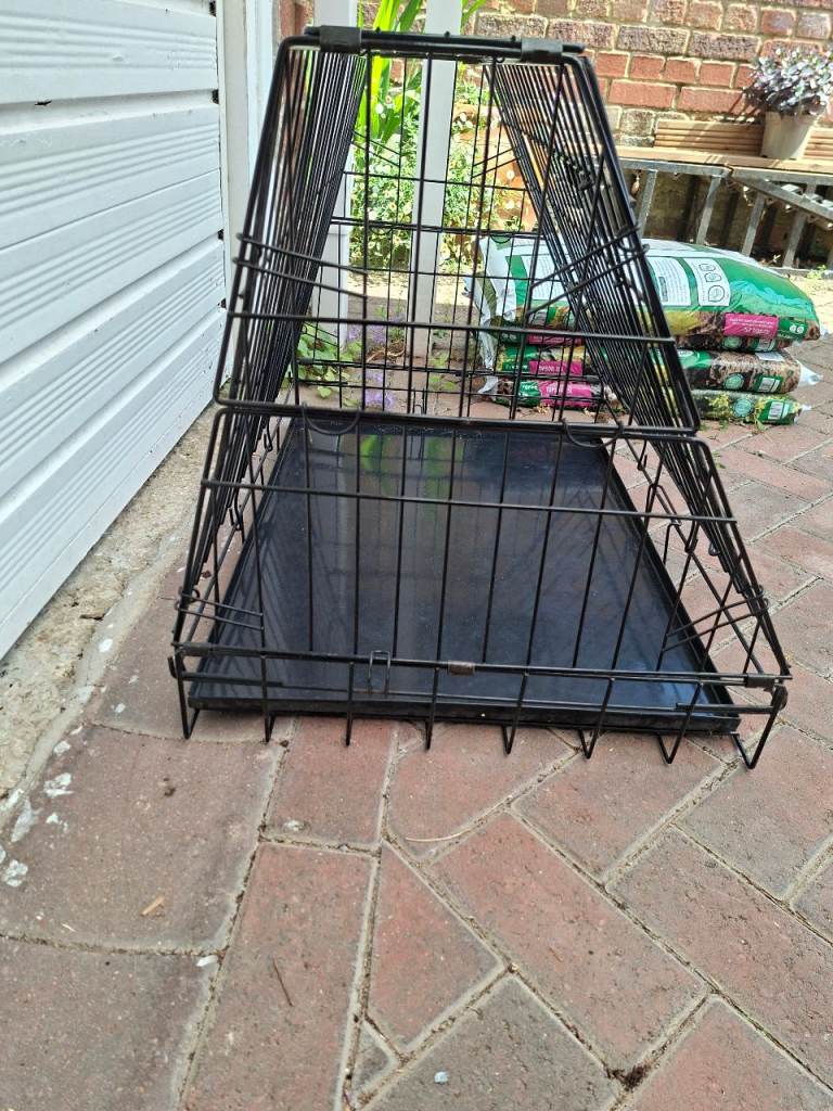 Dog cage, sloping front and back.