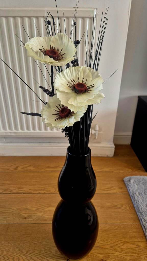 Black ceramic vase with faux flower arrangement