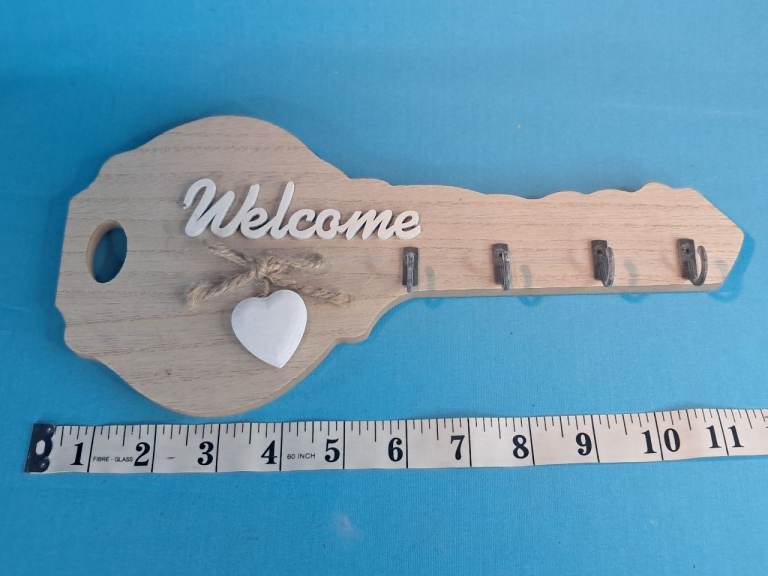 Wooden key-shaped wall mounted key holder with a  Welcome" sign and 4 hooks. 