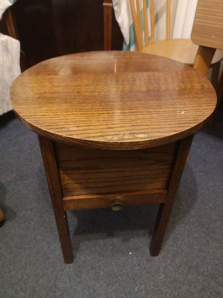 Oak circular topped needle work table with drawer