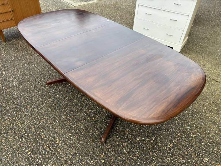 A beautiful and stylish Danish Rosewood extending dining table with extension leaf