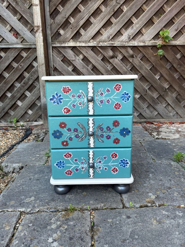 Hand-painted chest of drawers, carefully upcycled and decorated with a colourful floral design.