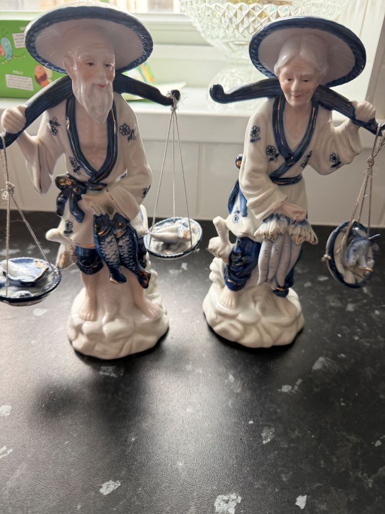 A pair of vintage Chinese blue and white porcelain fisherman figurines.