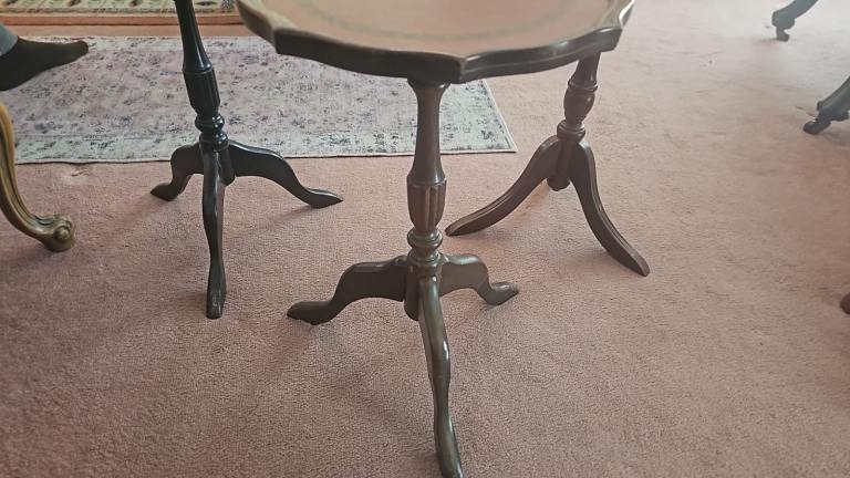 Vintage mahogany leather-topped tripod side tables