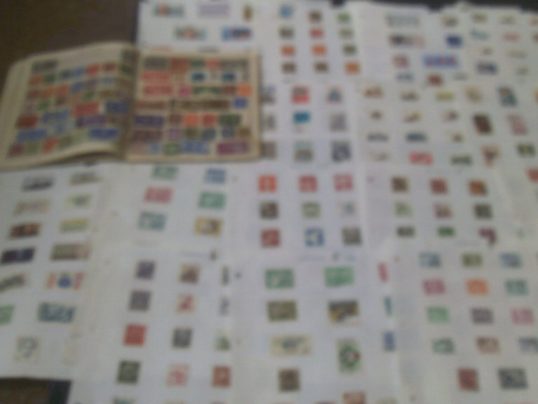 approx 1000 part world  used stamps in album +  17  loose pages  