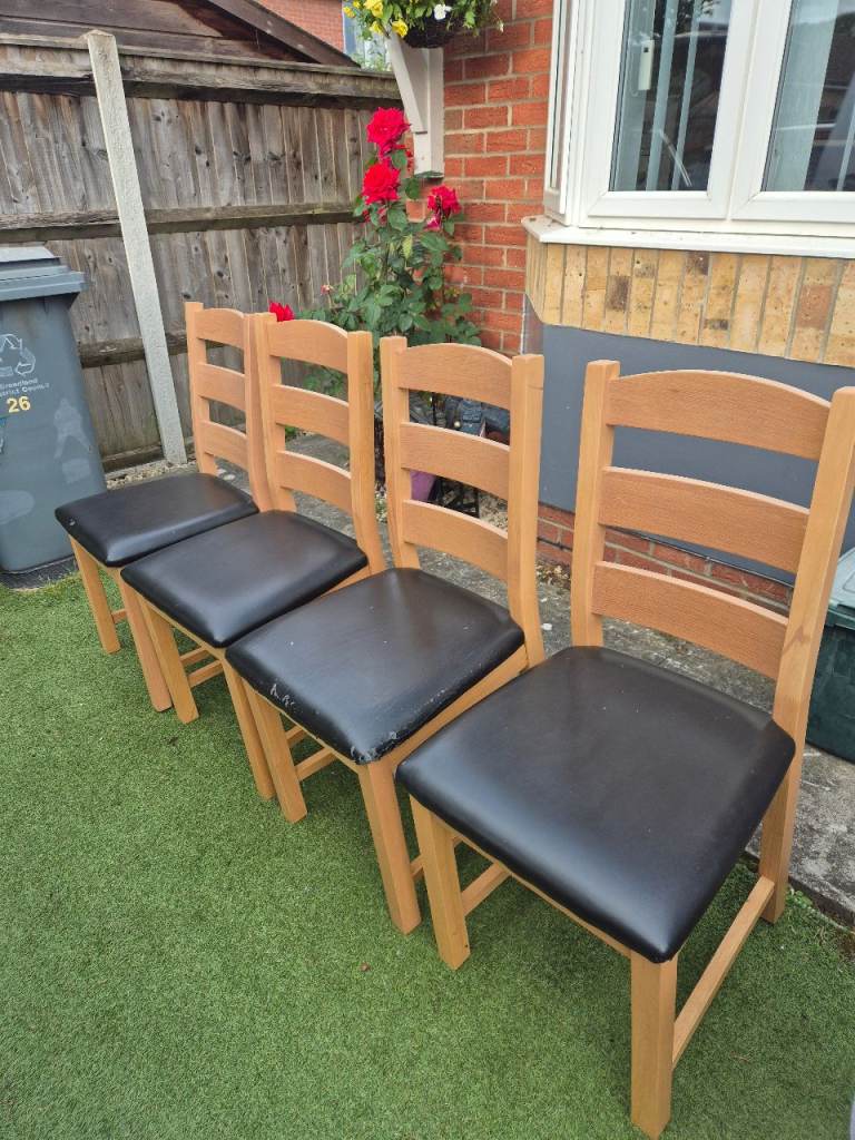 A set of 4 wooden framed dining chairs, delivery available 