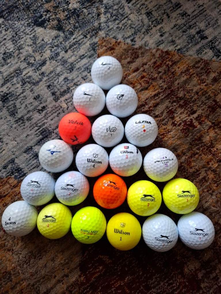 21 Various used golf balls