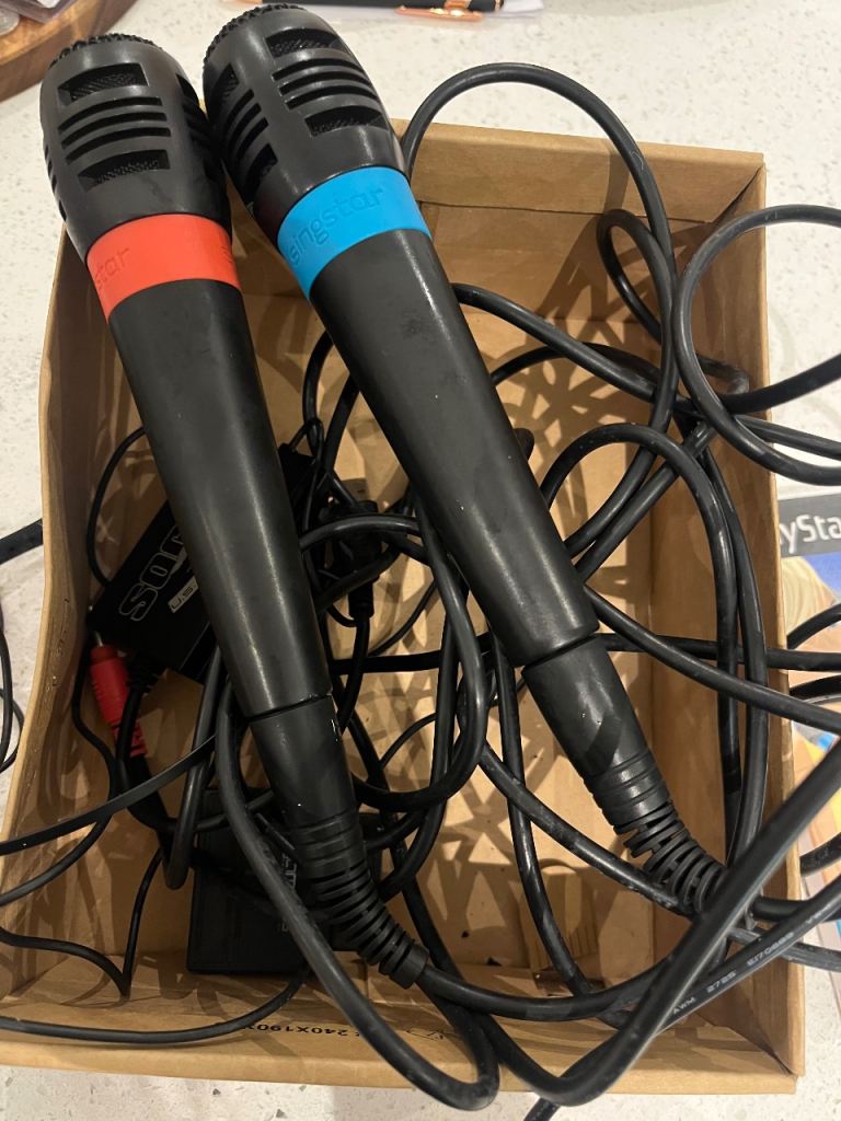 PlayStation 2 with games and microphones 