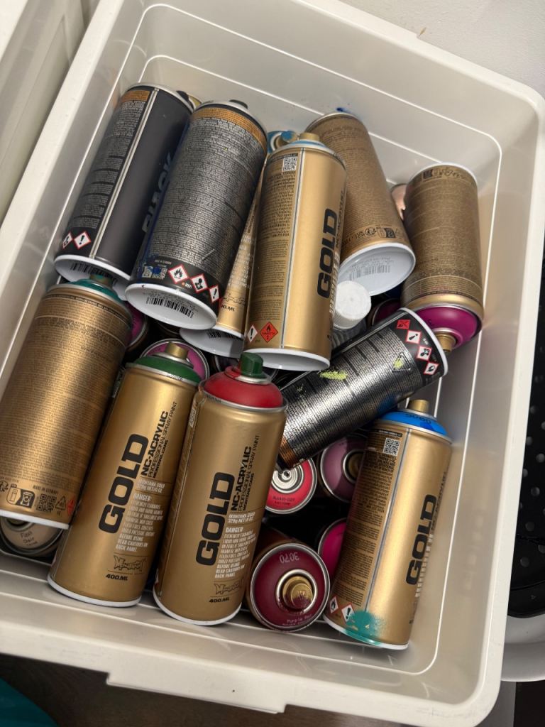 Mixed bag of various used and unused spray paints 