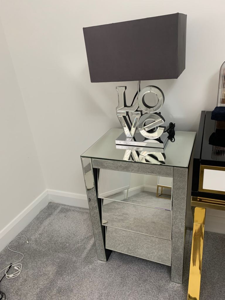 Morden stylish mirrored bedside table and lamp.