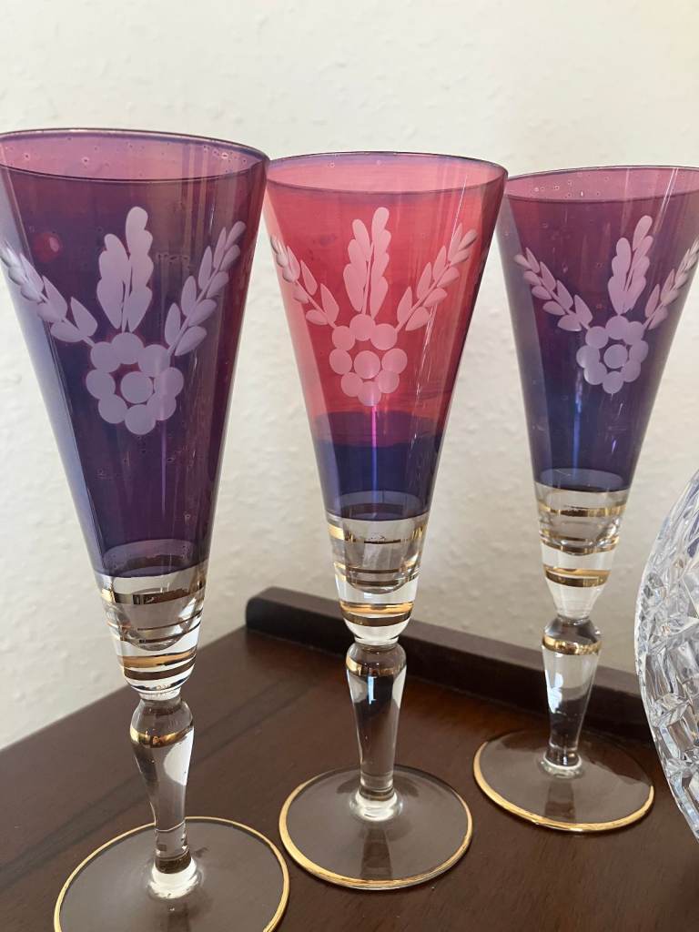 Heavy glass decanter and six vintage wine glasses.