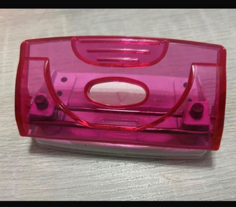 Small hole punch. Pink top. 