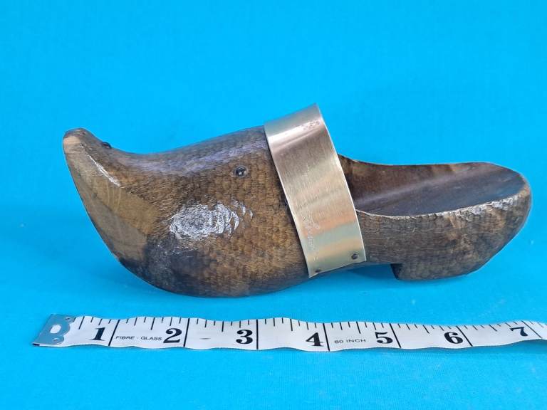 This is a vintage hand-carved wooden clog, also known as a sabot, decorative item. 