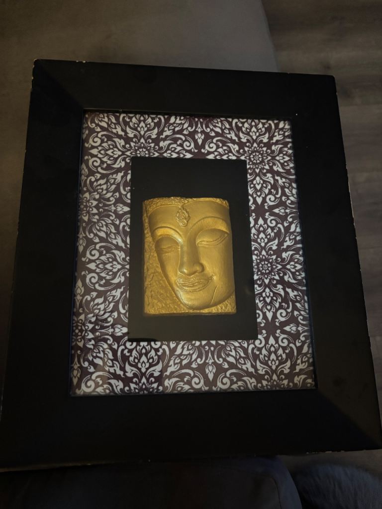 Gold Buddha face framed