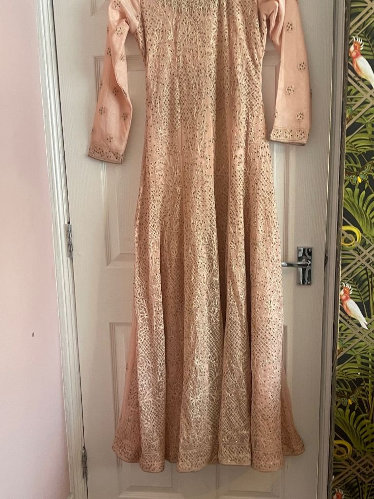 Ladies pink long sleeved dress with leggings and dupata.