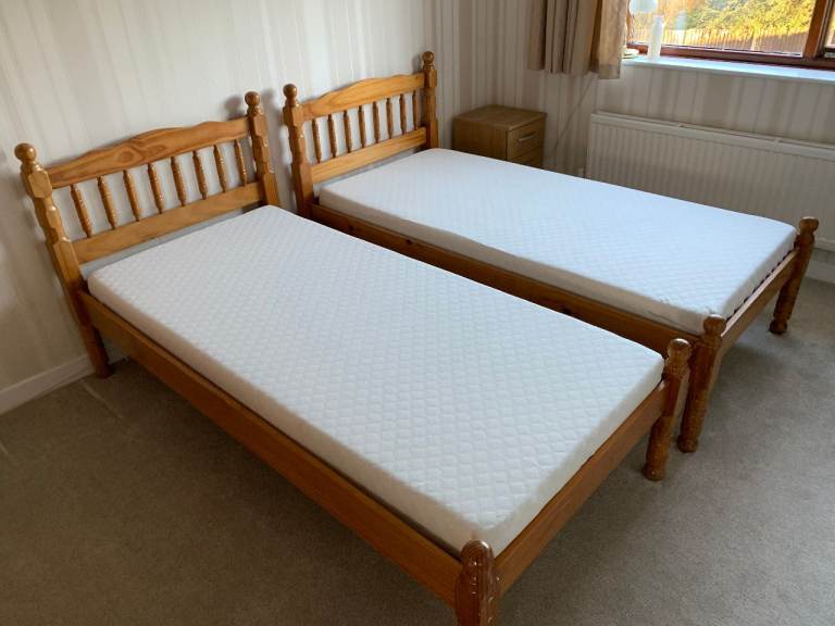2 pine single beds with mattresses