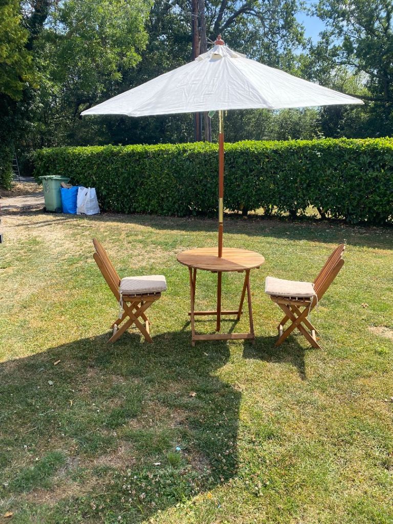 Rowlinson teak garden table and two chairs plus parasol 