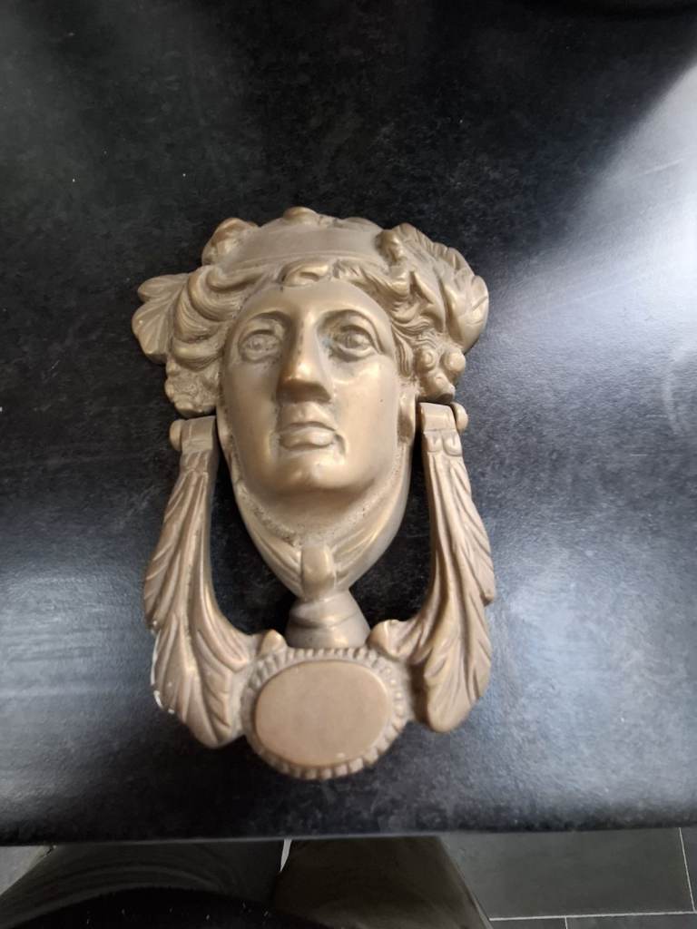 Brass coloured door knocker