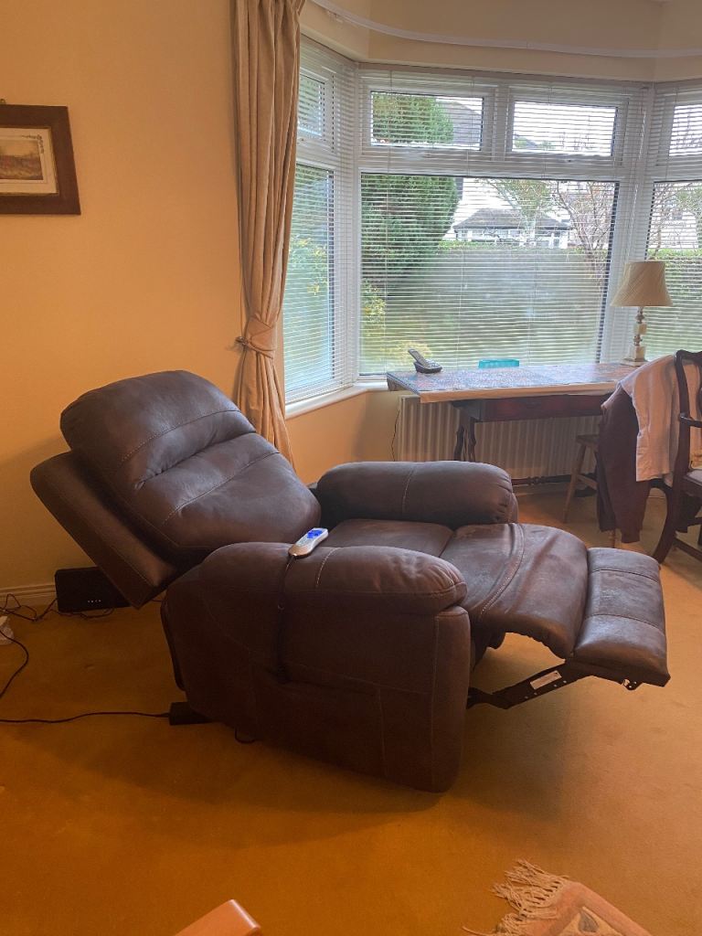 Electric rise and fall armchair in dark grey. 