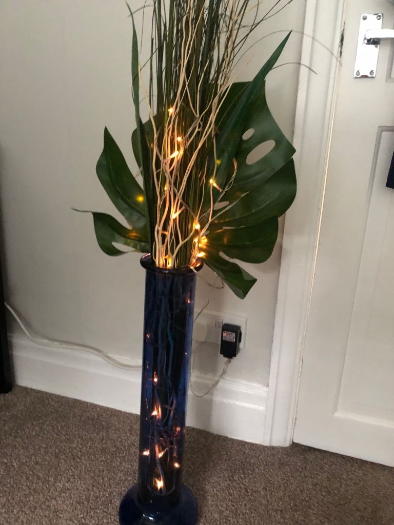 blue glass vase with dec and lights 