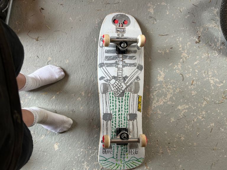 White Skateboard with Skull Design – Good Condition