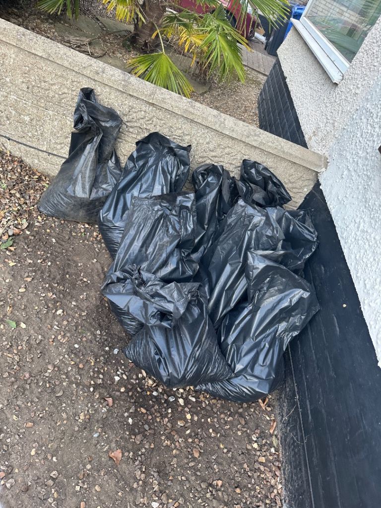 Bags of shingle and shingle with soil 